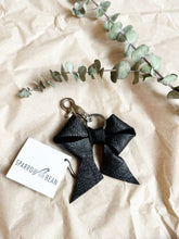 Load image into Gallery viewer, Black leather bows with keychain and lobster clip