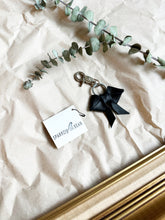 Load image into Gallery viewer, Black leather bows with keychain and lobster clip