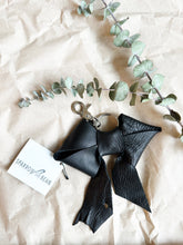 Load image into Gallery viewer, Black leather bows with keychain and lobster clip
