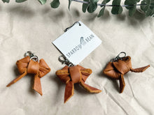 Load image into Gallery viewer, Redish brown leather bow keychain
