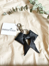 Load image into Gallery viewer, Black leather bows with keychain and lobster clip
