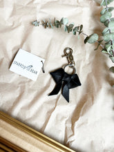 Load image into Gallery viewer, Black leather bows with keychain and lobster clip
