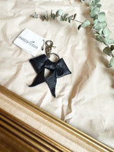 Load image into Gallery viewer, Black leather bows with keychain and lobster clip
