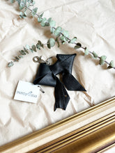 Load image into Gallery viewer, Black leather bows with keychain and lobster clip
