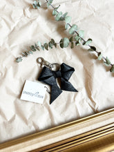 Load image into Gallery viewer, Black leather bows with keychain and lobster clip
